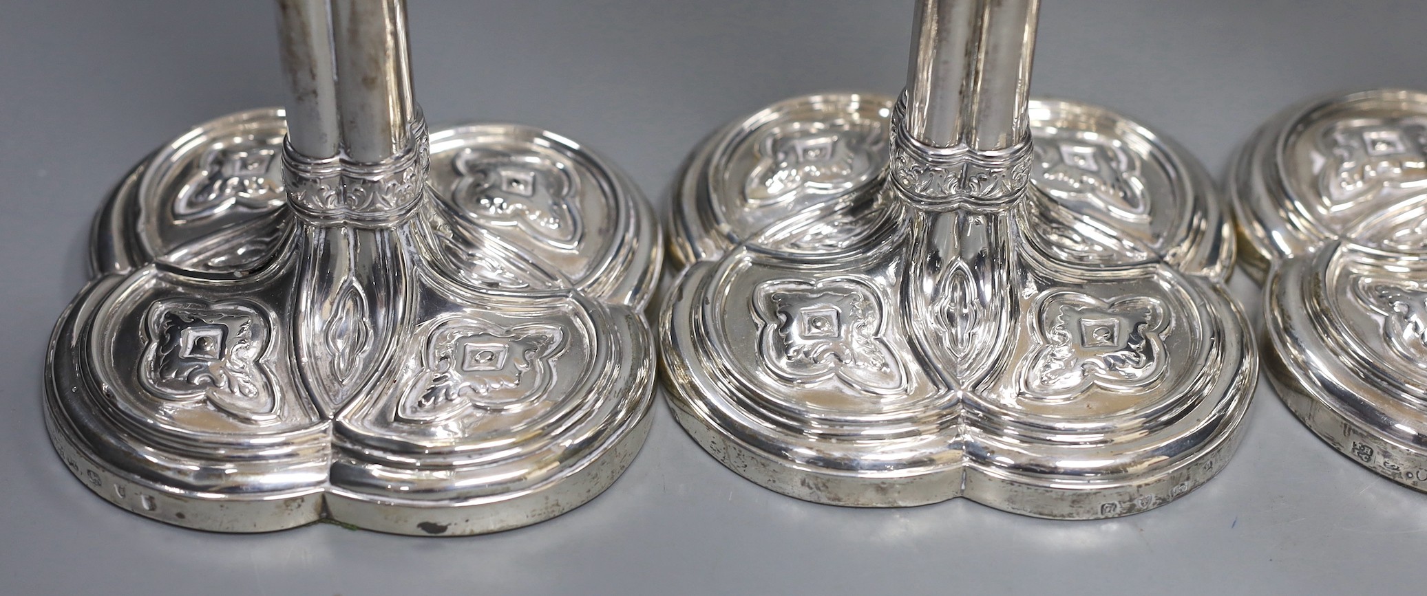 A set of four early George III silver gothic cluster column candlesticks, on cusped quatrefoil bases, by Hannam or Hammond & Carter, London, 1763, 28.8cm, weighted (holes).